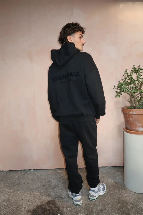 Fear of God Essentials Limo Black — hoodie noir profond porté